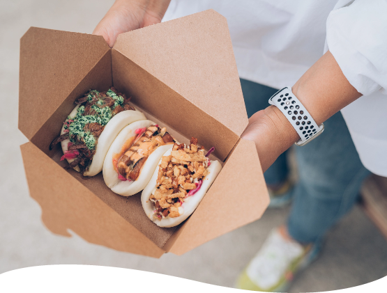 Open takeout container with three baos from Bao Boys Food Truck in Ann Arbor Michigan