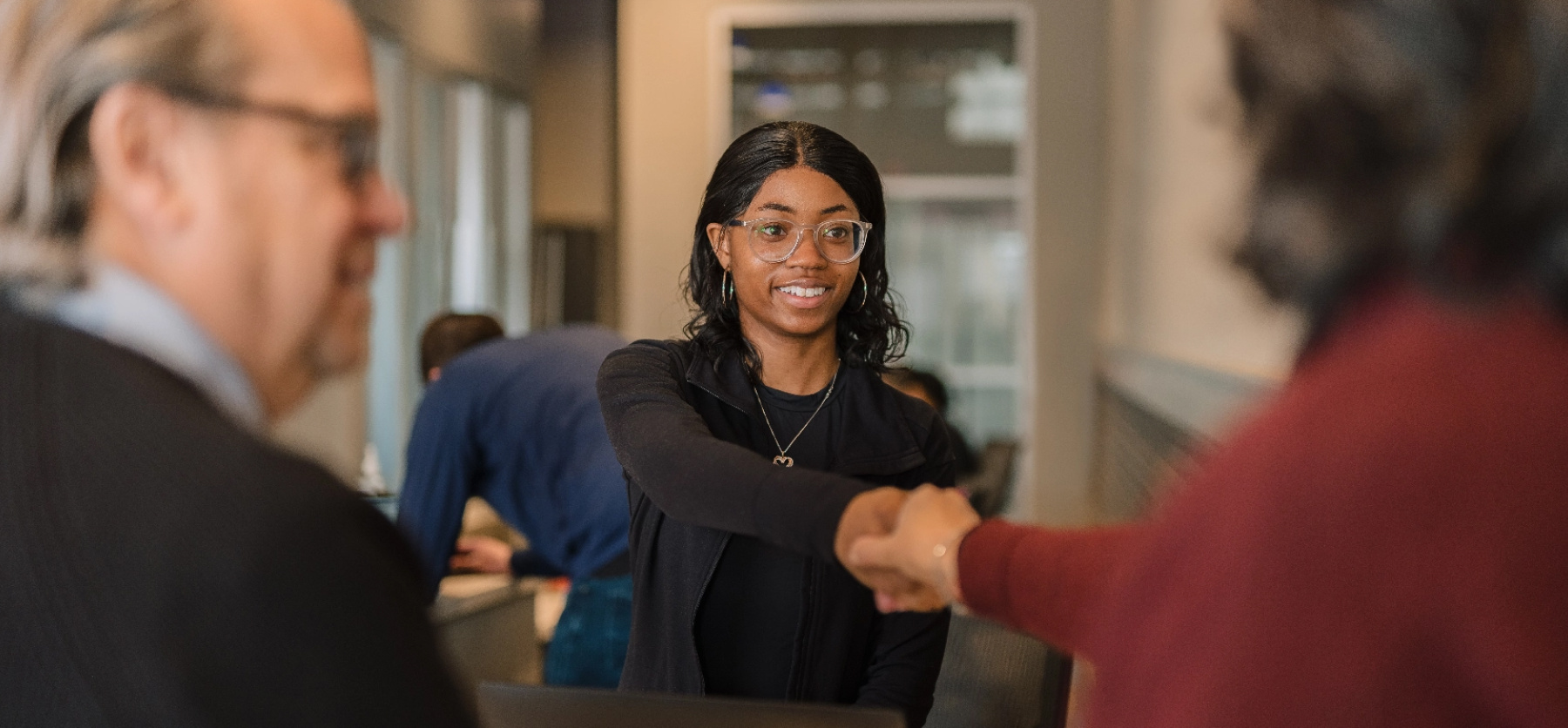 A lake trust team member shakes hands with a member.